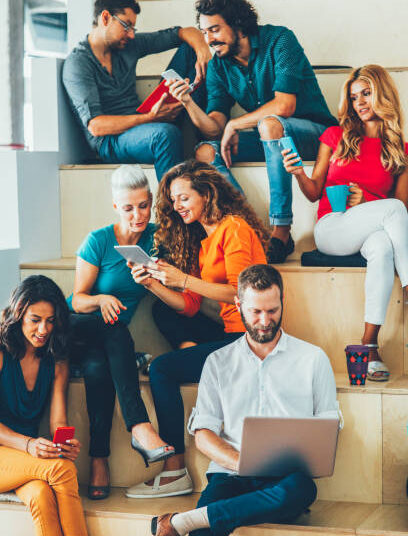 Large group of people using different devices or reading books.